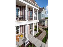 Inviting multi-Gathering homes with covered porch, white columns, and paved walkways at 998 Kinzer Ave, Carmel, IN 46032