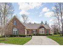 Charming brick home featuring manicured landscaping, a circular driveway, and classic architectural details at 10109 Fergus Ave, Carmel, IN 46032