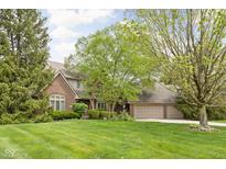 Charming two-story brick home with a well-manicured lawn and mature trees at 13778 Driftwood Dr, Carmel, IN 46033
