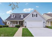 Charming home featuring a well-manicured lawn, a welcoming front porch, and a two-car garage at 15129 Smithfield Dr, Westfield, IN 46074