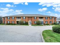 Inviting brick condo building with meticulously maintained landscaping and ample parking at 1632 Queensbridge Sq # 7, Indianapolis, IN 46219