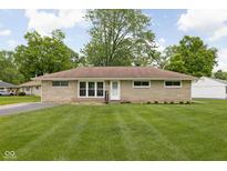 Charming brick ranch home with lush green lawn and mature trees, perfect for suburban living at 207 Stephen Ct, Indianapolis, IN 46280