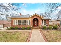 Charming brick home featuring a classic arched entryway and well-manicured front yard at 251 E South St, Franklin, IN 46131