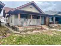 Charming home with a covered front porch and classic architectural details at 330 N Beville Ave, Indianapolis, IN 46201