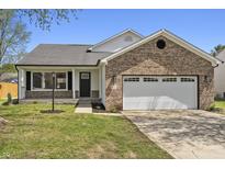 Charming single-story home featuring a brick facade and an attached two-car garage at 4057 Knollwood Ave, Franklin, IN 46131
