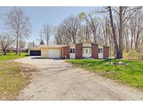Charming brick home with a spacious yard and long gravel driveway at 4389 S Brooklawn Dr, New Palestine, IN 46163