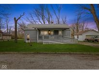 Charming home featuring a welcoming porch with a ramp and a well-maintained front yard at 8722 Shelby St, Indianapolis, IN 46227