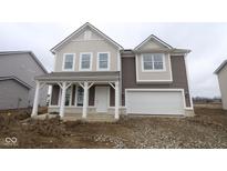 Charming two-story home with a welcoming front porch and attached two car garage at 10033 Redwood Peak Ln, Indianapolis, IN 46259