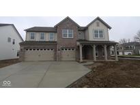 New two-story home featuring a brick facade, attached two-car garage, and covered front porch at 10543 Banyan Wood Ct, Indianapolis, IN 46239