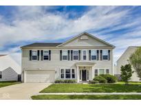 Traditional two-story home featuring a well-maintained lawn and an attached two-car garage at 12552 Majestic Way, Fishers, IN 46037