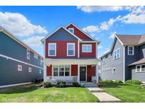 Charming two-story home with red siding, blue accents, and a welcoming front porch at 2018 Cornell Ave, Indianapolis, IN 46202