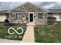 Charming single-story home with stone facade and well-maintained lawn at 2706 Country Estates Dr, Indianapolis, IN 46227