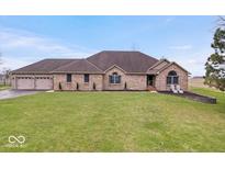 Charming brick home with a well-manicured lawn and a welcoming two-car attached garage at 4223 W State Road 234, McCordsville, IN 46055
