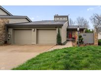 Charming home with a two-car garage, stone accents and well-manicured lawn at 4561 Coles Dr, Columbus, IN 47201