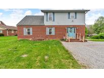 Two-story home featuring brick accents, a light blue door, and light blue shutters at 5301 Old Smith Valley Rd, Greenwood, IN 46143
