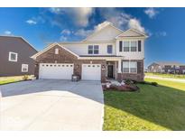 Handsome two-story home featuring brick and siding, along with a well-kept lawn at 5839 Altar Bell Cir, Greenwood, IN 46143