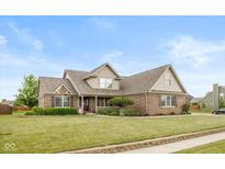 Charming brick home featuring manicured lawn and tasteful landscaping, creating inviting curb appeal at 732 Trillium St, Lebanon, IN 46052