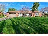 Well-maintained ranch home featuring a green lawn, brick facade, and attached two car garage at 8808 Rocky Hill Rd, Indianapolis, IN 46217