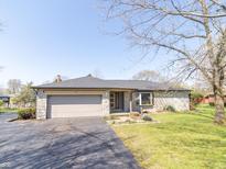 Charming single-story home featuring stone facade, attached garage and well-manicured lawn at 918 N 700 W, Greenfield, IN 46140