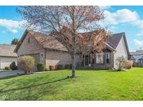 Charming brick home with well-manicured lawn and mature tree in a desirable neighborhood at 10518 Greenway Dr, Fishers, IN 46037