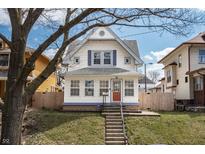 Charming two-story home with a well-maintained yard and inviting front entrance at 1417 Sturm Ave, Indianapolis, IN 46201