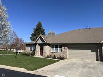 Charming brick home featuring an attached garage and a well-manicured lawn at 18346 Piers End Dr, Noblesville, IN 46062