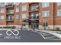 A well-maintained brick building with black awning entrance and balconies at 20971 Shoreline Ct # 214, Noblesville, IN 46062