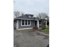 Charming single-story home featuring a covered porch and driveway at 2124 W 64Th St, Indianapolis, IN 46260