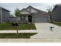 Charming single-story home with a two-car garage, manicured lawn, and a welcoming front entrance at 2199 Warbler St, Danville, IN 46122