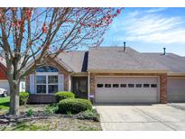 Charming brick home with an attached garage, manicured landscaping, and mature tree at 2755 Rylee Ct, Greenwood, IN 46143