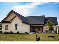 Charming brick home with a covered porch and manicured lawn on a sunny day at 2932 Camden Ct, Greenwood, IN 46143
