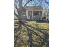 Charming home featuring a covered porch and well-maintained front yard at 5338 Traditions Dr, Indianapolis, IN 46235