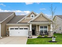 Charming single-Gathering home boasts manicured lawn, covered porch, and attached two-car garage at 6026 Rockdell Dr, Indianapolis, IN 46237