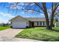 Charming single-story home featuring a two-car garage and a well-maintained front yard with mature trees at 6026 Sally Ann Cir, Indianapolis, IN 46237