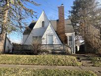 Charming two-story home featuring a unique triangular roofline and a quaint front porch at 614 E 5Th St, Anderson, IN 46012