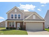 Charming two-story home with brick and vinyl siding, complemented by a well-manicured lawn at 6681 Keepsake Dr, Whitestown, IN 46075