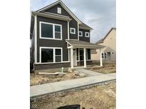 New construction two-story home with dark siding, white trim, covered porch, and freshly poured concrete sidewalk at 799 Rose Garden Way, Westfield, IN 46074