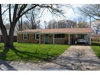 Charming ranch-style home with a quaint front yard, brick facade and a covered carport for convenient parking at 838 Highland Dr, Whiteland, IN 46184