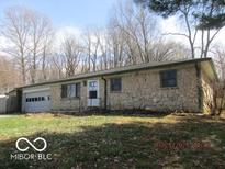 Charming stone house featuring an attached garage and a well-maintained front yard at 8625 Edith St, Martinsville, IN 46151