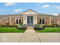 Charming single-story brick home with well-manicured lawn and beautiful landscaping at 958 Tamarack Cir N Dr, Indianapolis, IN 46260