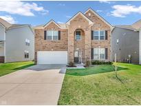 Beautiful two-story brick home with attached two car garage and manicured lawn at 1075 Barberry Dr, Greenwood, IN 46143