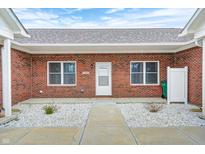 Charming brick home featuring a white front door, large windows, and stone landscaping for added curb appeal at 11975 Civic Cir, Mooresville, IN 46158