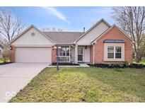 Charming home with a two-car garage, landscaped yard, and brick accents at 12527 Saksons Blvd, Fishers, IN 46038