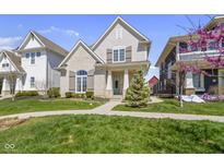 Beautifully landscaped front yard with mature trees and well-maintained lawn at 1444 Waterleaf Dr, Westfield, IN 46074