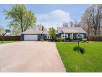 Charming blue home with a well-manicured lawn, attached garage, and a basketball hoop at 16471 E 196Th St, Noblesville, IN 46060