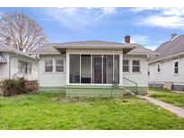 Charming bungalow with a screened front porch and easy access to the entry door at 2035 Koehne St, Indianapolis, IN 46202