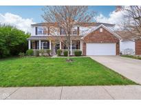 Charming two-story home with brick and siding, lush lawn, and attached two car garage at 2236 Willowview Dr, Indianapolis, IN 46239