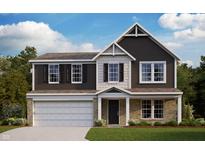 Charming two-story home featuring a brick and vinyl facade, complemented by a two-car garage and covered porch at 325 Atlas Dr, Lebanon, IN 46052