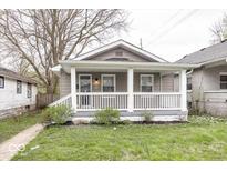 Charming home featuring a quaint front porch and well-manicured lawn at 4742 Primrose Ave, Indianapolis, IN 46205
