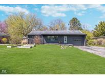 Charming single-story home featuring a well-manicured lawn and an attached garage at 6242 N Rural St, Indianapolis, IN 46220